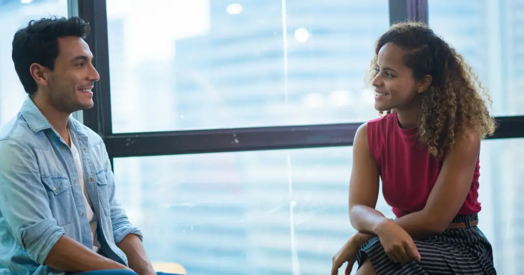 A man and a woman having a conversation.