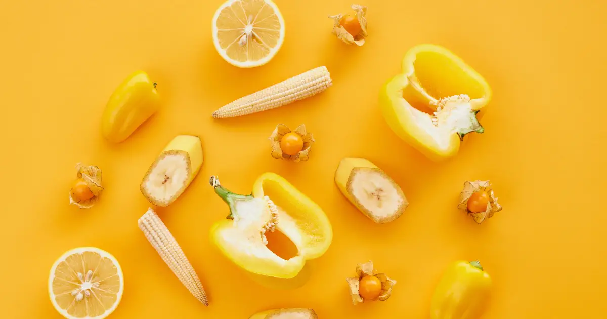 A collection of yellow fruits on a yellow background
